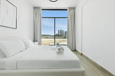 a bedroom with a bed and a large window at BLVD Boutique Style Apartment Gym Pool Balcony JVC in Dubai
