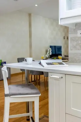 a kitchen with a white table and chairs in a kitchen at Marina View, 2BR Ideal for Groups, Walk to beach in Dubai