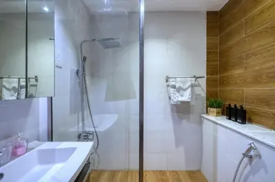 a bathroom with a shower and a sink at Marina View, 2BR Ideal for Groups, Walk to beach in Dubai