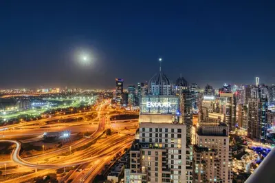 a city lit up at night with traffic at Family and Group Friendly Near Beach Metro and Marina in Dubai