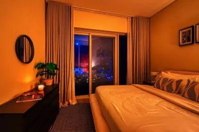 a hotel room with a bed and a window at Family and Group Friendly Near Beach Metro and Marina in Dubai
