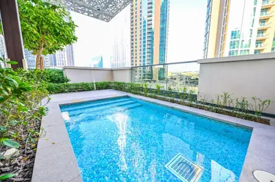 a swimming pool on top of a building with tall buildings at Modern 1BR in ACT Tower 1 in Dubai