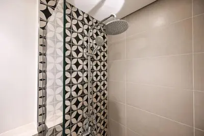 a shower with a shower head in a bathroom at Modern 2BR Golfville Dubai in Dubai