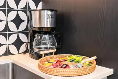 a basket of candy on a counter next to a blender at Modern 2BR Golfville Dubai in Dubai