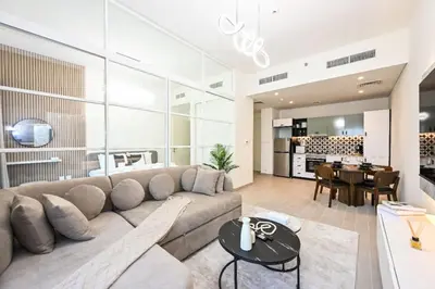 a living room with a couch and a table at Modern 2BR Golfville Dubai in Dubai
