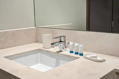 a bathroom counter with a sink and a mirror at 2BR Pool Burj View Dubai Mall in Dubai