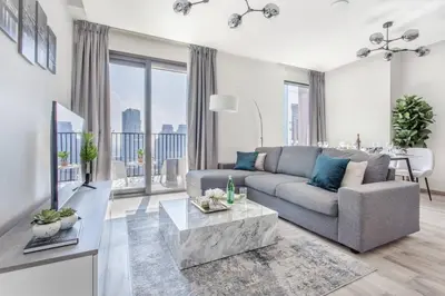 a living room with a couch and a table at Waterfront 1 BR - Canal View - Fully Furnished - Business Bay - 15 Mins to Dubai Mall and Burj Khalifa in Dubai