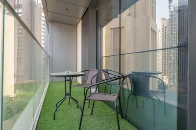 a balcony with chairs and tables on a building at Stunning 1 Bedroom at Boulevard Point with Infinity Pool connected to Dubai Mall by Luxury Space in Dubai
