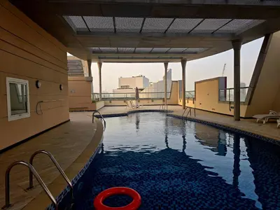 a swimming pool on the top of a building at Best Deal I Spacious Apartment I Full Amenities including Balcony, Pool, Gym, Kids Play Area in Dubai