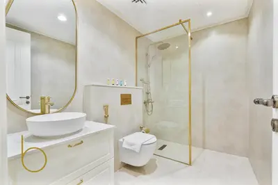 a bathroom with a shower and a toilet and a sink at Bookable - 3 Bedroom in Mayas Geneva, JVC in Dubai