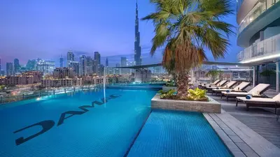 a swimming pool on top of a building with a city skyline at Full Burj Khalifa Panoramic View - Luxury Stay at Damac Maison Distinction in Dubai