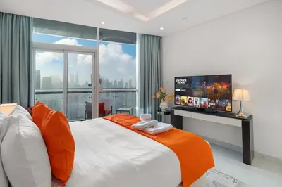 a bedroom with a large bed with a flat screen tv at Full Burj Khalifa Panoramic View - Luxury Stay at Damac Maison Distinction in Dubai