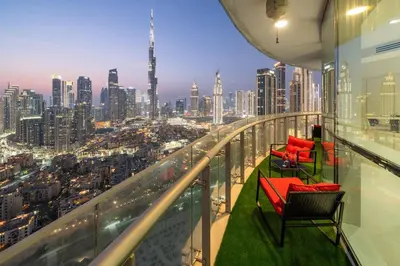 a balcony with two chairs and a view of a city at Full Burj Khalifa Panoramic View - Luxury Stay at Damac Maison Distinction in Dubai