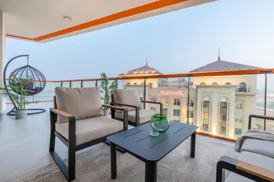 a living room with chairs and a table at Full Dubai Skyline View on High Floor in Dubai