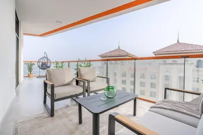 a living room with a table and chairs on a balcony at Full Dubai Skyline View on High Floor in Dubai