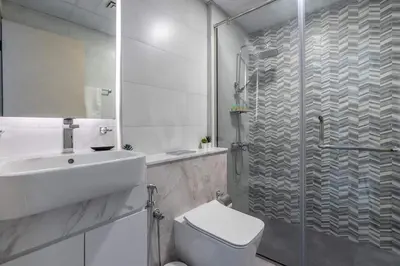 a bathroom with a shower and a toilet and a sink at Full Dubai Skyline View on High Floor in Dubai