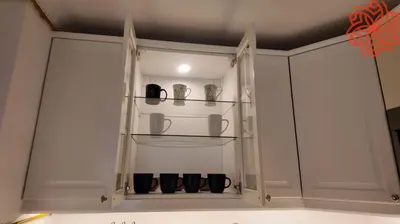 a white cabinet with cups and vases in it at Amazing 3 bedrooms in Mayas geneva in Dubai