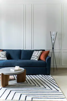 a living room with a blue couch and a coffee table at Design 1br Apartment with Dubai Marina View in Marina Gate 2 in Dubai