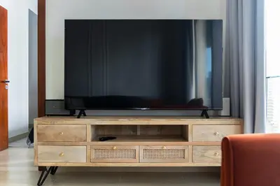 a flat screen tv sitting on top of a wooden dresser at Design 1br Apartment with Dubai Marina View in Marina Gate 2 in Dubai