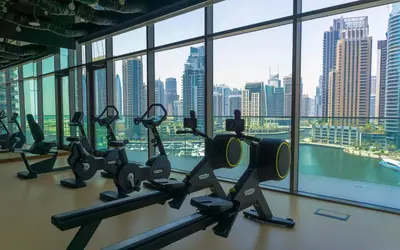 a gym with a view of a city skyline at Design 1br Apartment with Dubai Marina View in Marina Gate 2 in Dubai