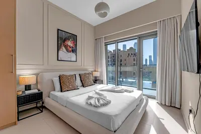 a bedroom with a large bed and a large window at Luxury 2BR Downtown Burj View, Heart of Downtown in Dubai