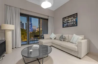 a living room with a couch and a glass table at Luxury 2BR Downtown Burj View, Heart of Downtown in Dubai