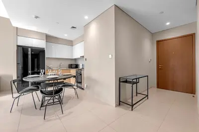 a kitchen and dining room with a table and chairs at Luxury 2BR Downtown Burj View, Heart of Downtown in Dubai