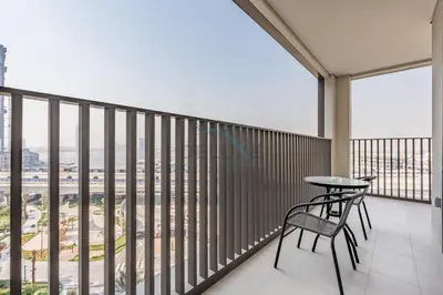 a balcony with a table and chairs on it at Creek Views 1BR, Short Drive to Ras Al Khor Sanctuary and Festival City Mall, Rosewater at Creek Beach Building 3, Dubai Creek Harbour by Deluxe Holiday Homes in Dubai