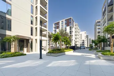 an empty street in a city with tall buildings at Creek Views 1BR, Short Drive to Ras Al Khor Sanctuary and Festival City Mall, Rosewater at Creek Beach Building 3, Dubai Creek Harbour by Deluxe Holiday Homes in Dubai