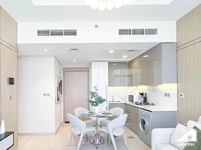 a kitchen and dining room with a table and chairs at Elegant 1BR at Azizi Riviera l Prime Location in Dubai