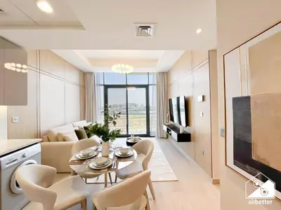 a living room with a table and chairs at Elegant 1BR at Azizi Riviera l Prime Location in Dubai