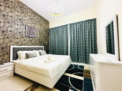 a bedroom with a large white bed in a room at Stylish 1 Plus Maid's 5 mins to Metro at Marina Park in Dubai