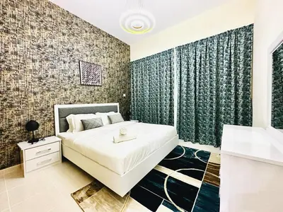 a bedroom with a large bed and a bathroom at Stylish 1 Plus Maid's 5 mins to Metro at Marina Park in Dubai