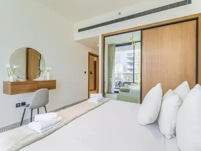 a bedroom with a large bed with white pillows at TRPS - Binghatti Lavender, JVC - Premium 1BR Retreat, Fully Furnished in Dubai