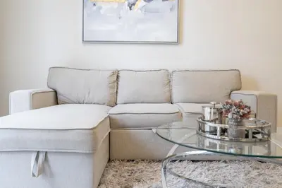 a living room with a couch and a glass table at Luxury Apartment l 2 min walk from Dubai Mall in Dubai