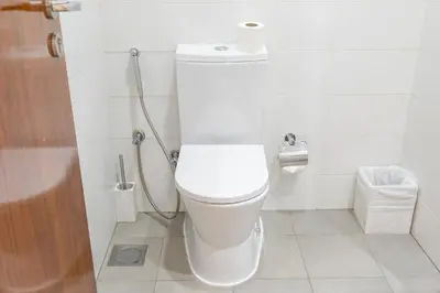 a white toilet in a bathroom with a shower at Luxury Apartment l 2 min walk from Dubai Mall in Dubai