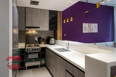 a kitchen with purple walls and a stove top oven at Beautiful Brand New Spacious 1BR in Dubai