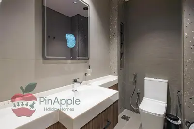 a bathroom with a sink and a toilet at Beautiful Brand New Spacious 1BR in Dubai