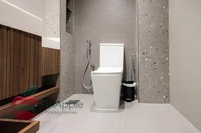 a bathroom with a toilet and a shower at Beautiful Brand New Spacious 1BR in Dubai