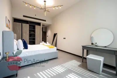 a bedroom with a bed and a mirror at Beautiful Brand New Spacious 1BR in Dubai