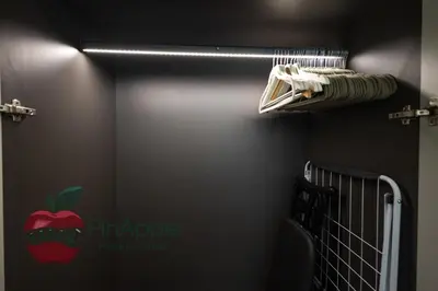 a bedroom with an apple sign on the wall at Beautiful Brand New Spacious 1BR in Dubai