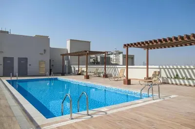 a swimming pool on the roof of a building at Luxury Studio Apartment in Dubai
