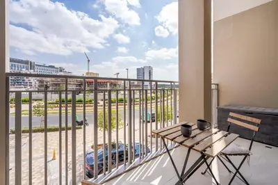 a balcony with a table and a view of a city at Luxury Studio Apartment in Dubai