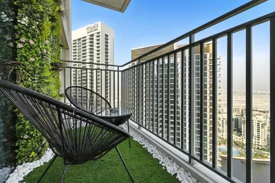 a balcony with a bench and a view of the city at Appealing 2BR at 17 Icon Bay, Dubai Creek Harbour in Dubai