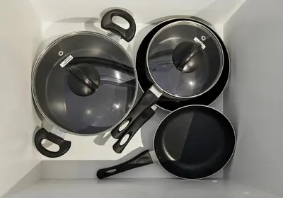a bunch of pots and pans hanging on a wall at Appealing 2BR at 17 Icon Bay, Dubai Creek Harbour in Dubai