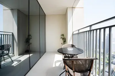 a room with a table and chairs on a balcony at Appealing 1BR at 17 Icon Bay, Dubai Creek Harbour in Dubai