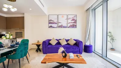 a living room with a purple couch and a table at Appealing 1BR at 17 Icon Bay, Dubai Creek Harbour in Dubai