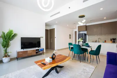 a living room with a table and a dining room at Appealing 1BR at 17 Icon Bay, Dubai Creek Harbour in Dubai