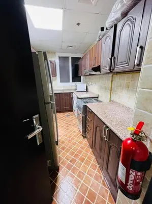 a kitchen with a fire hydrant in the middle of it at Smart Partition Room Barsha ! in Dubai