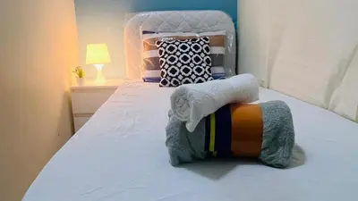 a bedroom with a bed with towels on it at The Pod Partition Room Al Barsha 1 in Dubai